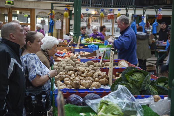 St Georges Market Veg stall selling potatoes and cabbage.