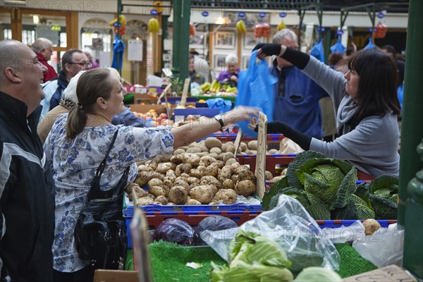 St Georges Market Veg stall selling potatoes and cabbage.