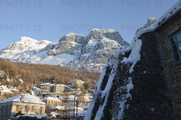 View of the small traditional Greek village Mikro Papigko or Little Papigko built underneath the mountain.