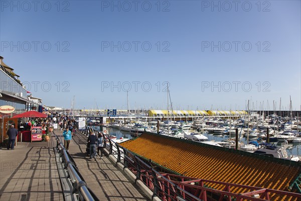 View along the boardwalk over boats moored in the Marina.