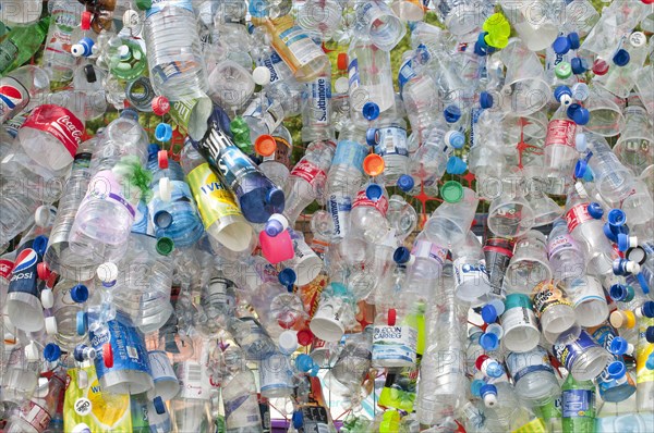 Plastic bottles attached to a wire fence at the WOMAD festival to highlight the need to recycle non-sustaninable materials.