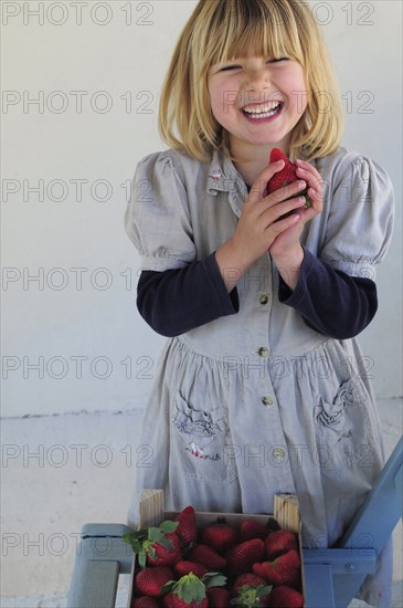 5 year old Eva eating first strawberries of the year in February.