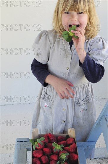 5 year old Eva eating first strawberries of the year in February.