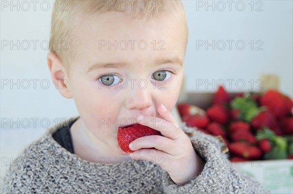 2 year old Oscar eating first strawberries of the year in February.