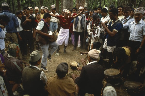 Nepal, Festivals, Male musicians and dancers at Dasain Mela festival in the woods. Photo : Liba Taylor
