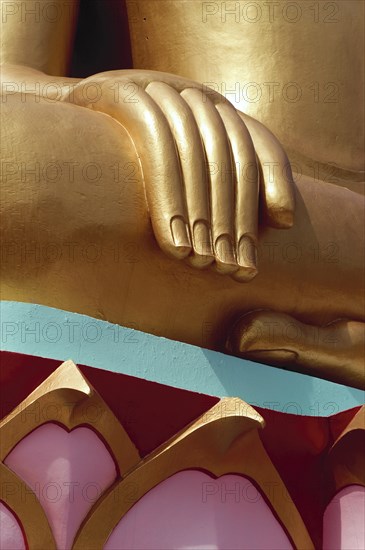 Thailand, Koh Samui, Large golden seated Buddha with detail of hand and colourful base. Photo : Derek Cattani