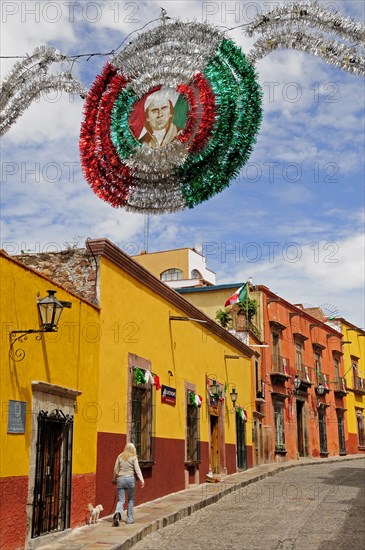 Mexico, Bajio, San Miguel de Allende, Independence Day decorations adorn colonial street lined by colourful buildings. Photo : Nick Bonetti
