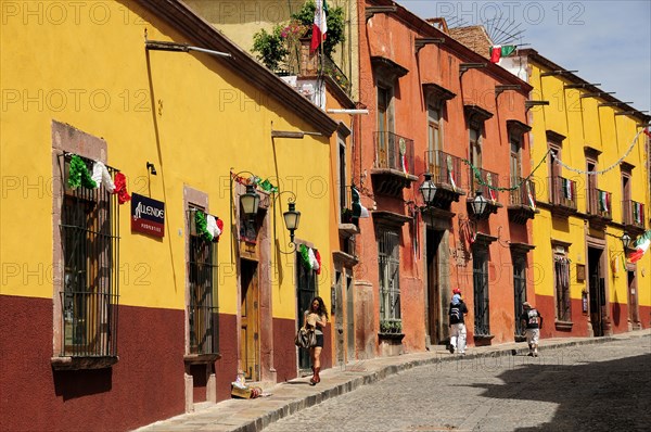 Mexico, Bajio, San Miguel de Allende, Independence Day decorations adorn colonial streets lined by brightly painted buildings. Photo : Nick Bonetti