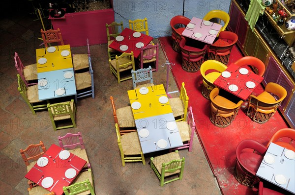 Mexico, Bajio, Queretaro, Elevated view looking down on tables in colourful restaurant interior. Photo : Nick Bonetti