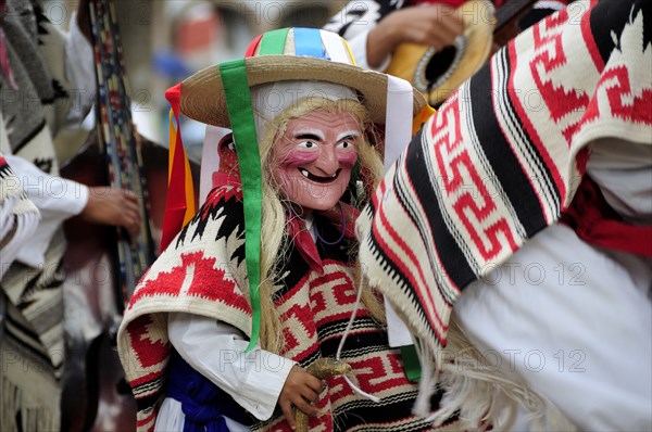 Mexico, Michoacan, Patzcuaro, Child wearing mask and costume for Danza de los Viejitos or Dance of the Little Old Men in Plaza Vasco de Quiroga. Photo : Nick Bonetti