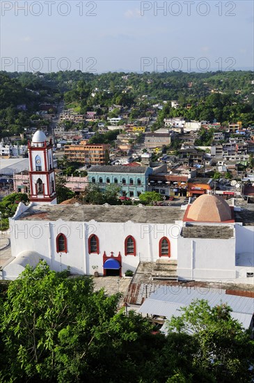 Mexico, Veracruz, Papantla, Views over Cathedral Zocalo and surrounding buildings set amongst trees. Photo : Nick Bonetti