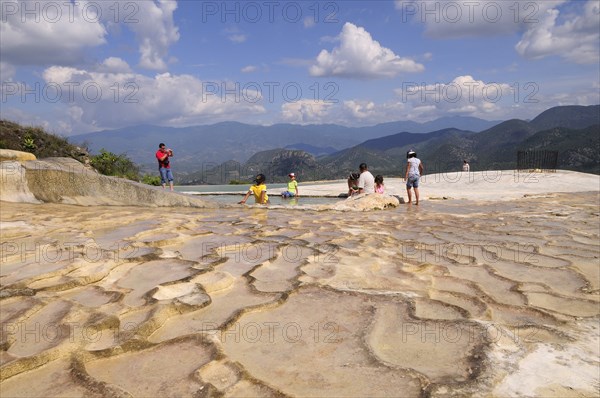 Mexico, Oaxaca, Hierve el Agua, Tourists beside limestone pool.. Photo : Nick Bonetti