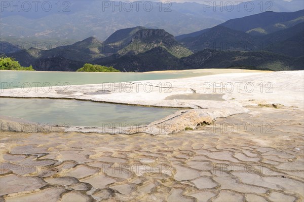 Mexico, Oaxaca, Hierve el Agua, Mountainous landscape with limestone pools in the foreground. Photo : Nick Bonetti