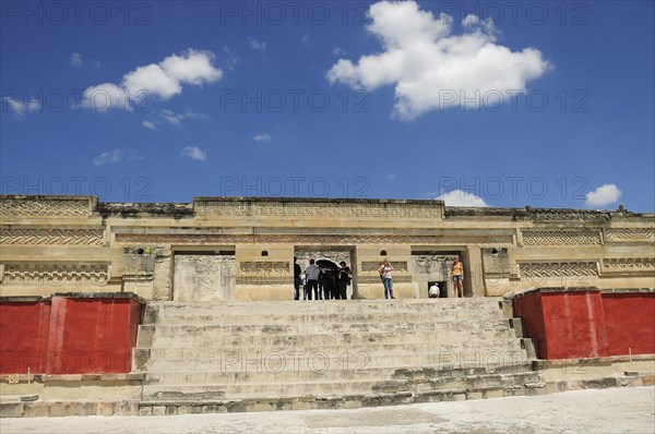 Mexico, Oaxaca, Mitla, Archaeological site Templo de las Columnas with tourist visitors standing at top of steps to entrance. Photo : Nick Bonetti