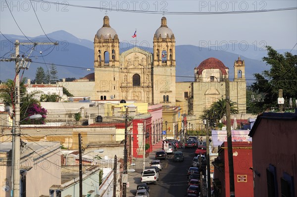 Mexico, Oaxaca, View towards church of Santo Domingo over street and rooftops of surrounding buildings. Photo : Nick Bonetti