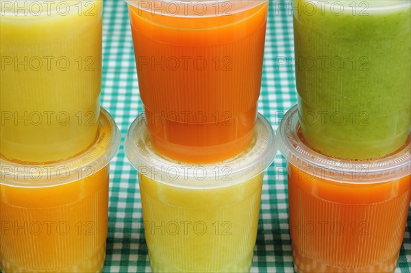 Mexico, Bajio, Guanajauto, Yellow green and orange jugos or fruit juices. Photo : Nick Bonetti