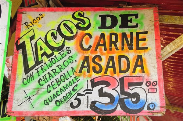 Mexico, Bajio, Zacatecas, Sign for taco food stall with highlighted text and price. Photo : Nick Bonetti