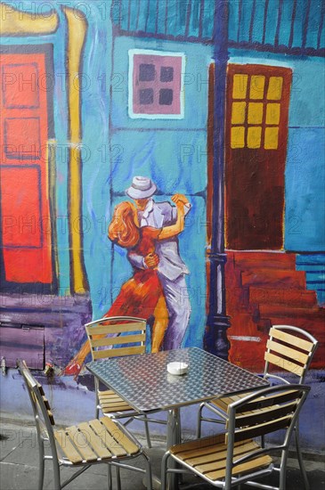 Mexico, Federal District, Mexico City, Condesa District Argentinian restaurant with painted exterior depicting couple dancing the tango and table and chairs in foreground.1. Photo : Nick Bonetti