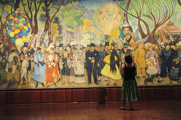 Mexico, Federal District, Mexico City, Visitor looking at Dream of a Sunday Afternoon in the Alameda mural by Diego Rivera in the Museo Mural Diego Rivera.. Photo : Nick Bonetti