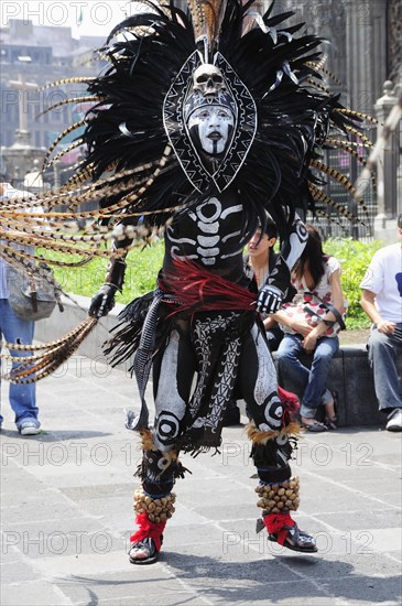 Mexico, Federal District, Mexico City, Michicoa Aztec dancer dressed in costume of Senor de Muerte or Mr Death for performance in the Zocalo. Photo : Nick Bonetti