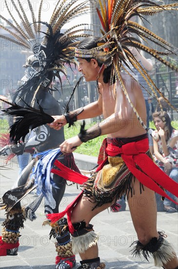 Mexico, Federal District, Mexico City, Michacoa Aztec dancers performing in the Zocalo. Photo : Nick Bonetti