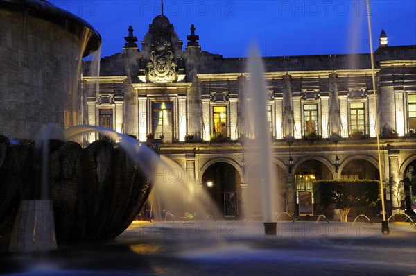 Mexico, Jalisco, Guadalajara, Fountain in foreground of exterior facade of Presidencia Municipal building at night on Plaza Guadalajara. Photo : Nick Bonetti