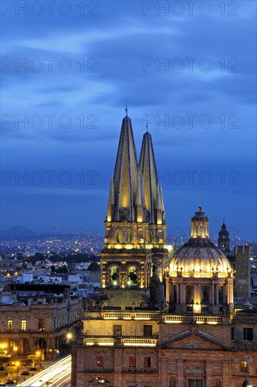 Mexico, Jalisco, Guadalajara, Cathedral domed roof and bell towers at night with city spread out behind. Photo : Nick Bonetti
