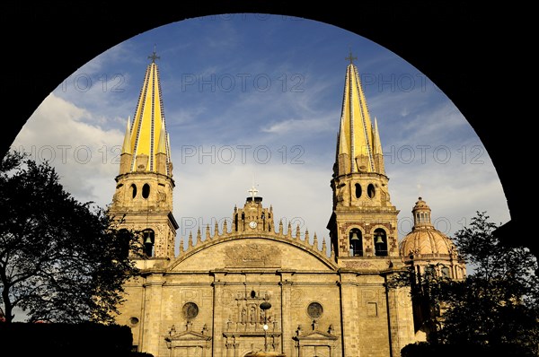 Mexico, Jalisco, Guadalajara, Plaza Guadalajara Exterior facade of cathedral and bell towers framed by archway in shadow.. Photo : Nick Bonetti
