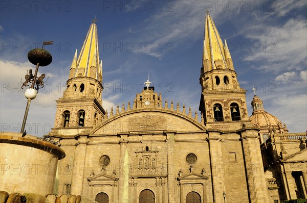Mexico, Jalisco, Guadalajara, Plaza Guadalajara Cathedral exterior facade and bell towers with part view of fountain in foreground.. Photo : Nick Bonetti