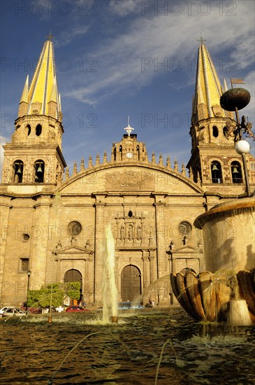 Mexico, Jalisco, Guadalajara, Plaza Guadalajara Cathedral exterior facade and bell towers with fountain in foreground.. Photo : Nick Bonetti