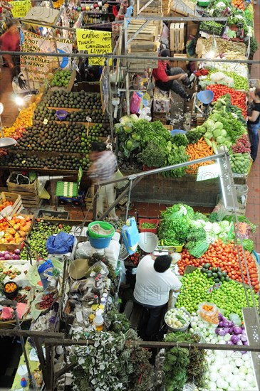 Mexico, Jalisco, Guadalajara, Mercado Libertad View down on vegetable market stall displays and vendors. Photo : Nick Bonetti
