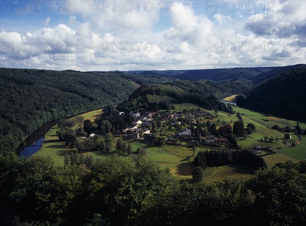 Belgium, Luxembourg, Frahan, View from Rochehaut over village beside the River Semois surrounded by hillsides covered by forest. Photo : Bryan Pickering