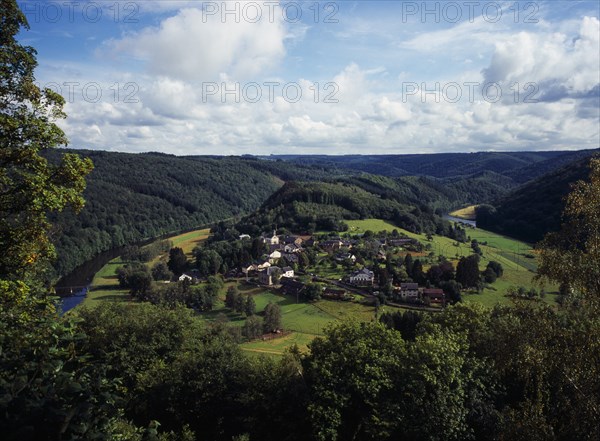 Belgium, Luxembourg, Frahan, View from Rochehaut over village beside the River Semois surrounded by hillsides covered by forest. Photo : Bryan Pickering