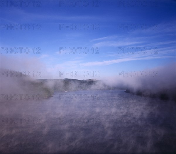 France, Bretagne, River Aulne, View from Pont de Terenez bridge looking west along River Aulne in dawn fog. Photo : Bryan Pickering