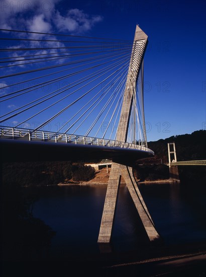 France, Bretagne, Finistere, Low viewpoint from South Bank right hand side looking up at the Pont de Terenez suspension bridge over the River Aulne completed in 2011.. Photo : Bryan Pickering