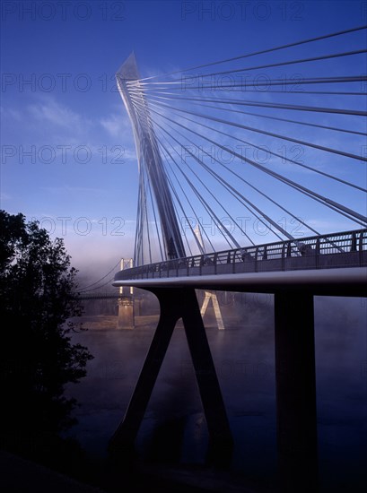 France, Bretagne, Finistere, Ile de Crozon. The new Pont de Terenez suspension bridge. View of east side with old bridge part seen beyond from north bank of the River Aulne. Photo : Bryan Pickering