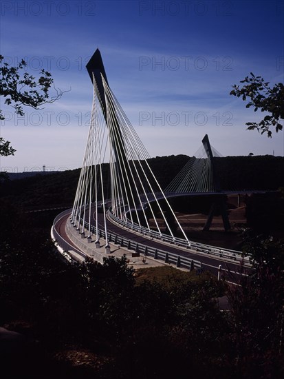 France, Bretagne, Finistere, Ile de Crozon. New Pont de Terenez suspension bridge view south from hillside above River Aulne shows two lane carriageway and suspension supports.. Photo : Bryan Pickering