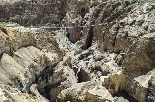Nepal, Upper Mustang, Rope Bridge, The bridge across the deep canyon near Ghyakar village. Photo : Sergey Orlov