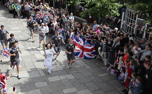 England, Kent, Tunbridge Wells, Olympic Torch relay running through the Pantiles. Photo : Sean Aidan