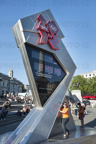 England, London, Trafalgar Square A young girl poses for a photograph in front of the Olympic Countdown clock. Photo : Paul Tomlins