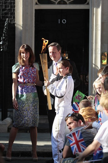 England, London, Olympic Torch relay in Downing Street Samantha and Prime Minister David Cameron welcome the torch. Photo : Sean Aidan