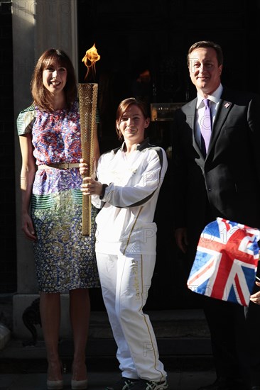 England, London, Olympic Torch relay in Downing Street Samantha and Prime Minister David Cameron welcome the torch. Photo : Sean Aidan