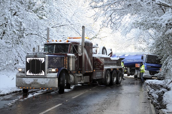 Weather, Winter, Snow, Recovery truck extracting a Jack-knifed fuel tanker on icy A22 main road near Nutley East Sussex after heavy snowfall.. Photo : Bob Battersby