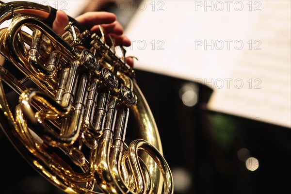 Music, Instruments, Brass, Detail of hand playing notes on a French Horn. Photo : Sean Aidan