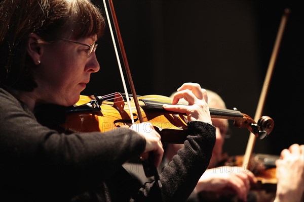 Music, Instruments, Strings, Violin Detail of woman playing in orchestra. Photo : Sean Aidan