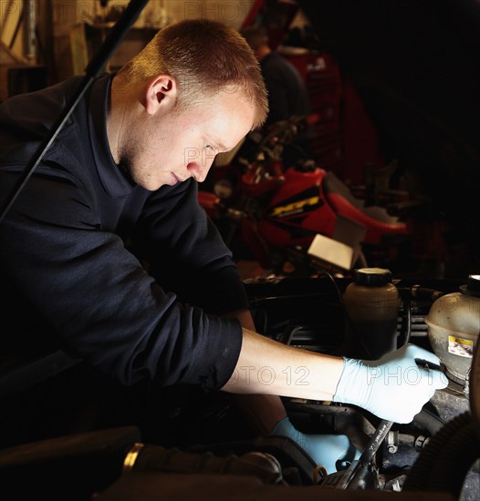 Transport, Road, Cars, Repair mechanic working on car in garage. Photo : Sean Aidan