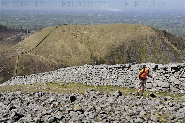 Ireland, County Down, Mourne Mountains, Hiker on Slieve Donard with Slieve Commedagh behind. Photo : Hugh Rooney