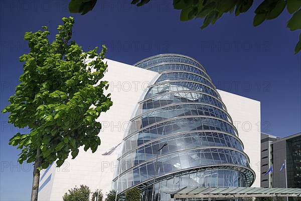 Ireland, County Dublin, Dublin City, Convention Centre building view of the facade with tree in foreground. Photo : Hugh Rooney