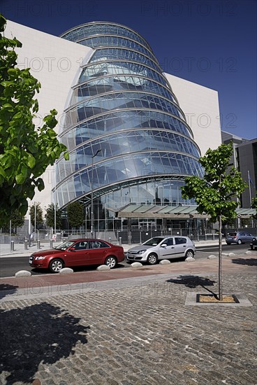 Ireland, County Dublin, Dublin City, Convention Centre building view of the facade with tree in foreground. Photo : Hugh Rooney