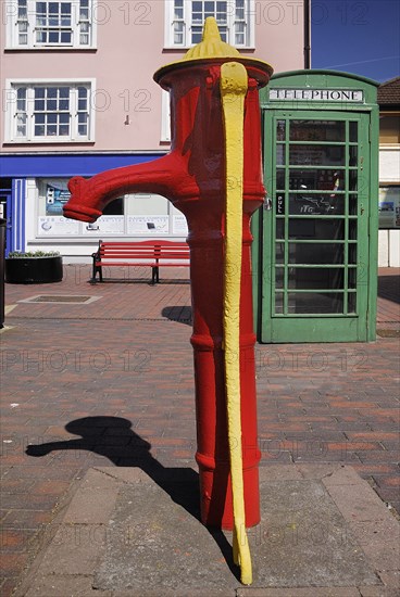 Ireland, County Cork, Kinsale, Colourful old water pump and telephone box. Photo : Hugh Rooney